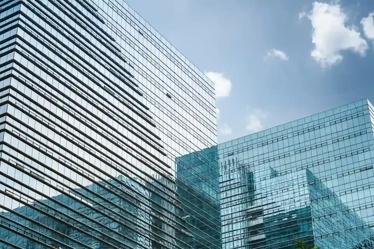 Modern glass office buildings reflecting the skyline and blue sky